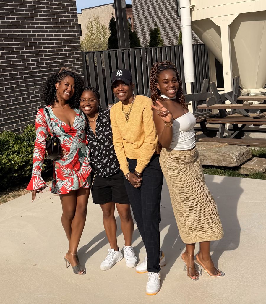 The Soft Queer Wealth community smiling together outdoors on a sunny afternoon